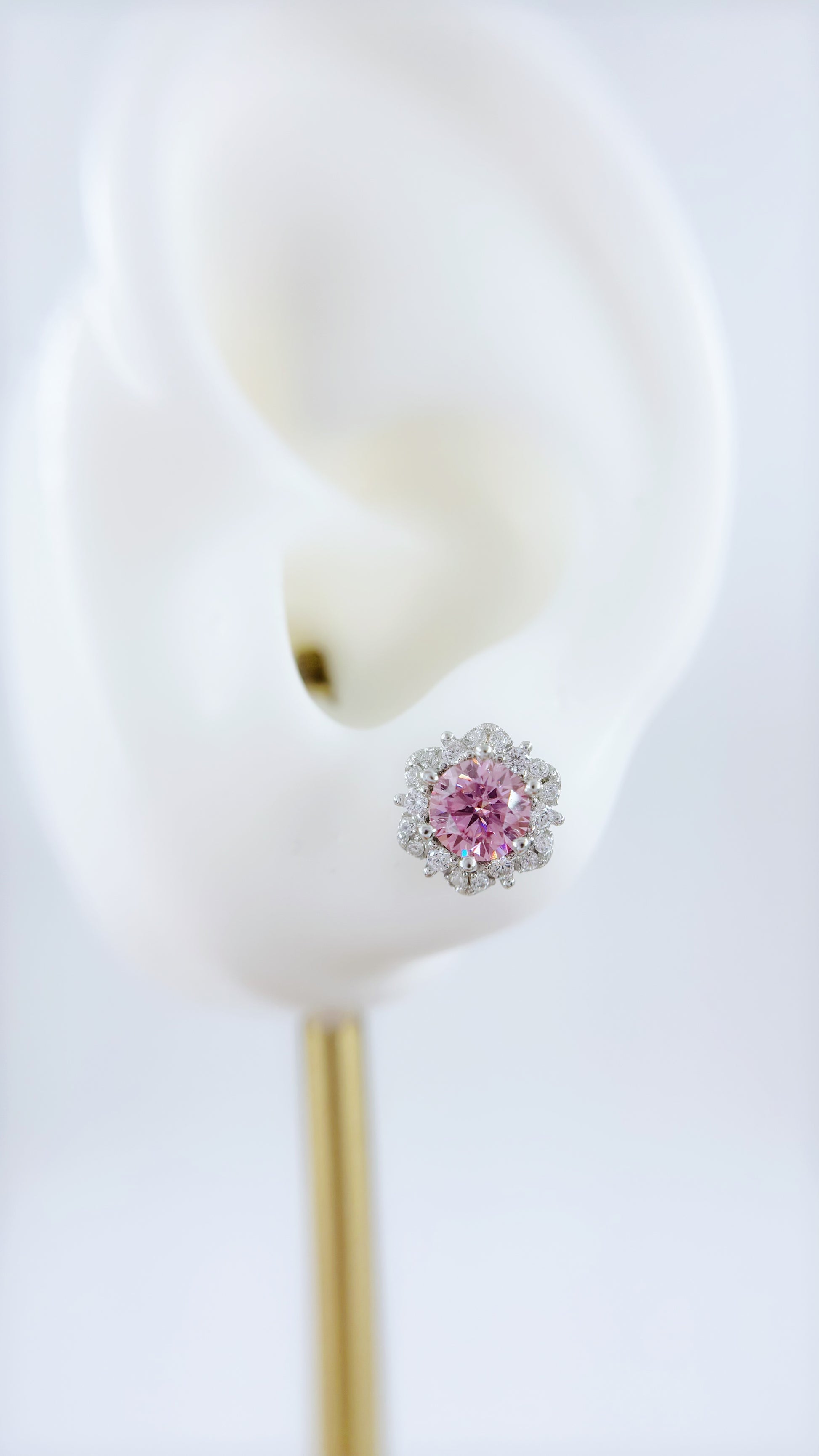 Pink moissanite earring on a white background
